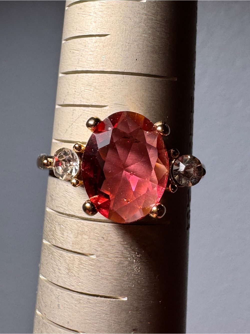 Gold Ring with Large Red Oval Stone and Clear Side Stones